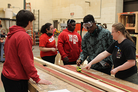 Photo of students working in the scene shop